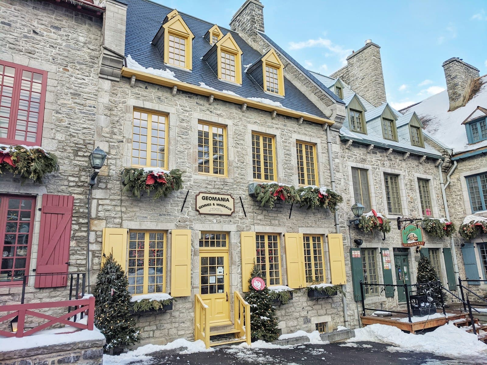 Snow-lined street of stone houses with painted shutters in Old Québec