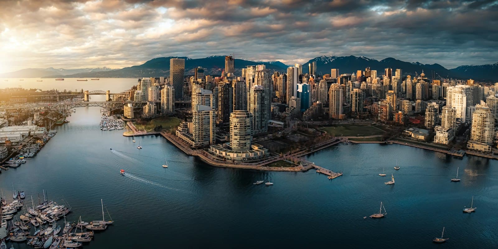 Downtown Vancouver from the air, harbour and forest meeting the towers
